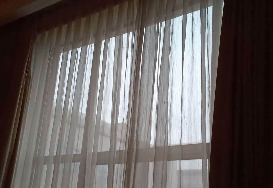 Morning light through a white sheer curtain (illustrative)